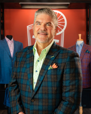 Profile photo of Bespoke Apparel Owner David Corbitt with background of store